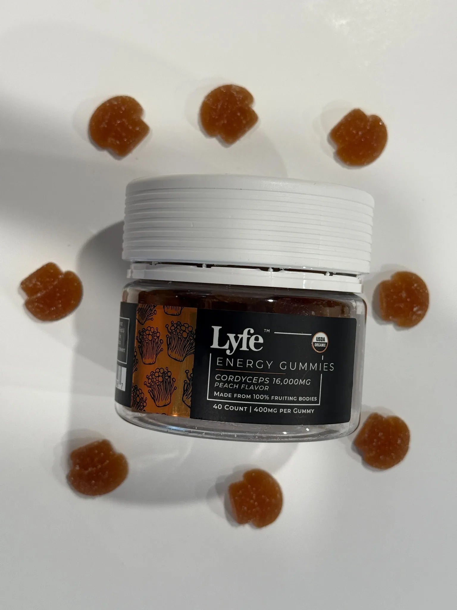 Lyfe Energy Gummies in a circular layout, highlighting mushroom-shaped peach gummies.
